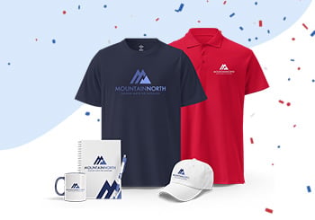 Branded polo shirts, a cap, and a custom mug representing FreeLogoServices' discounted apparel and promotional products collection